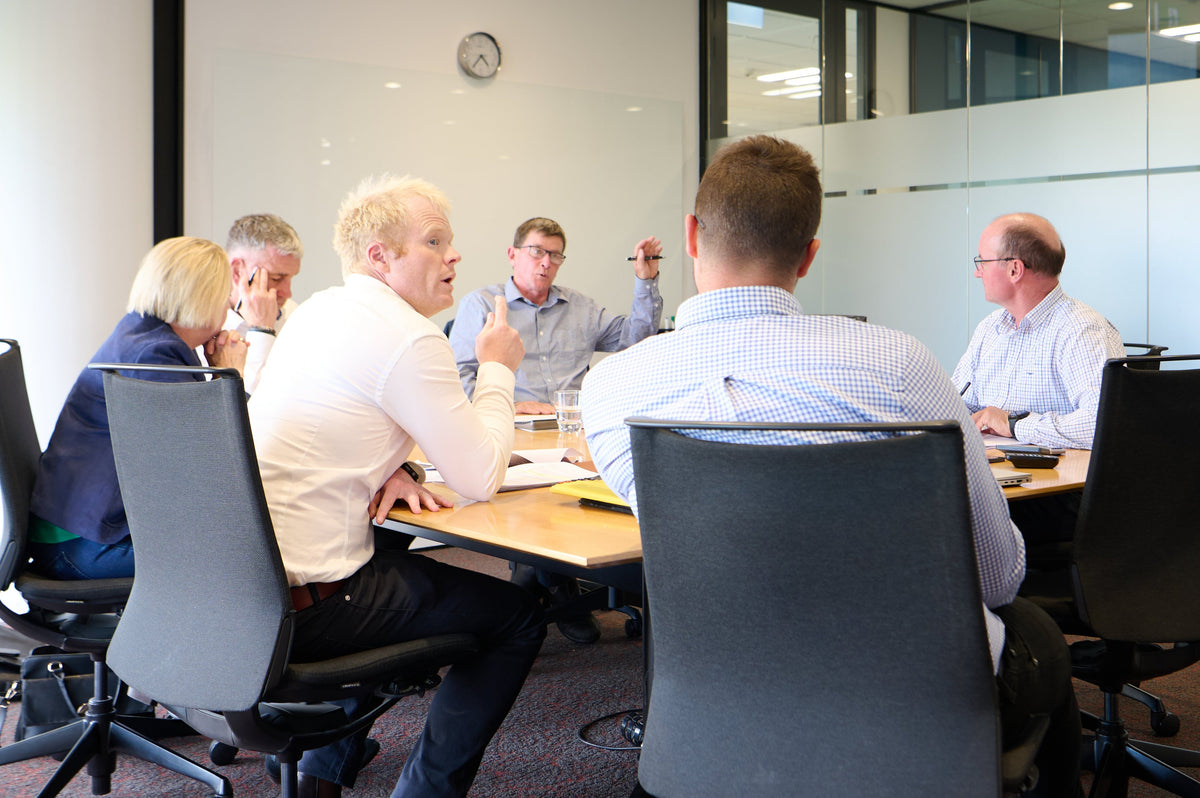 Robb Macbeth taking part in a board meeting around a table.